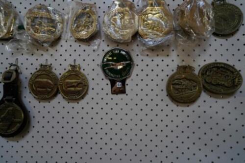 Tractor themed car grill badge and horse brasses