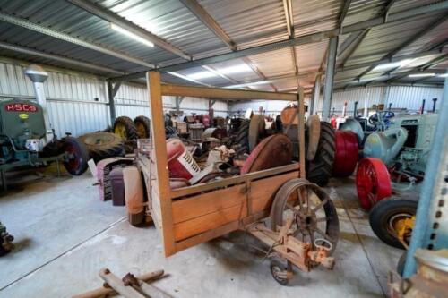TRAILER: Wooden car trailer with a large collection of tractor parts (mainly International)