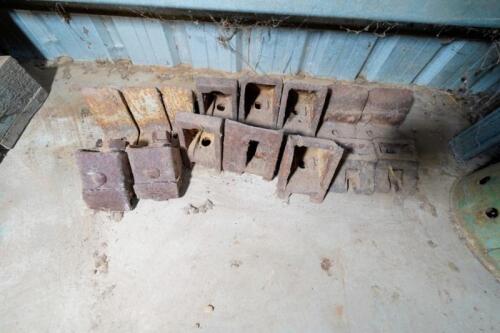 A collection of cast metal tractor wheel fittings