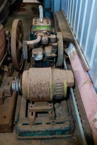 A stationary engine on cast metal base with separate motor
