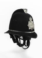 BOBBY: An original 21st Century English Metropolitan Police bobby helmet by Custodian Helmet in a large size, 25cm high