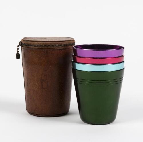 BEAKERS: Four vintage polychrome anodised beakers in leather case, 110cm high