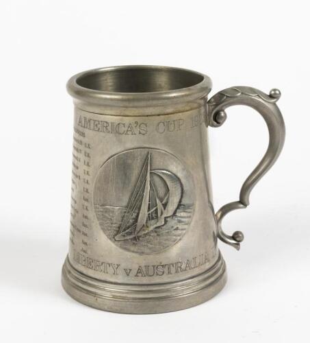 AMERICA'S CUP: A pewter and glass commemorative tankard from the 1983 America's Cup with central medallion featuring a yacht in relief and inscribed with defenders and challengers from 1870 to 1979