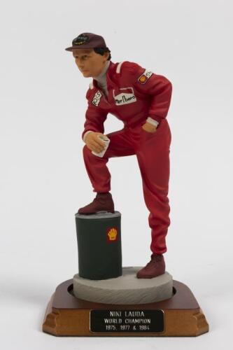 NIKI LAUDA: A 1:9 scale limited edition (455/2500) cold cast porcelain resin figure of Niki Lauda sculpted by Paul Szeiler for Endurance Lt, on wooden base with engraved plaque, NIB and accompanied by a COA from The Art of Sport, 21.5cm high