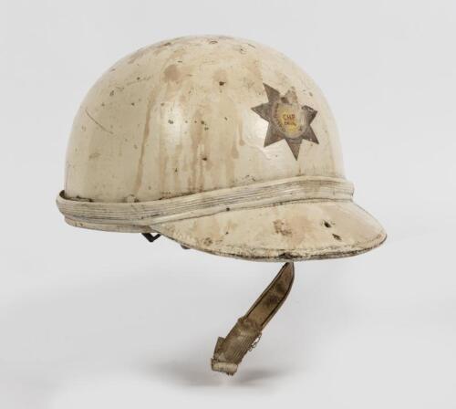 RACING HELMET: A vintage racing helmet with peak, fitted with canvas straps and a leather neck and ear flaps, no maker or size