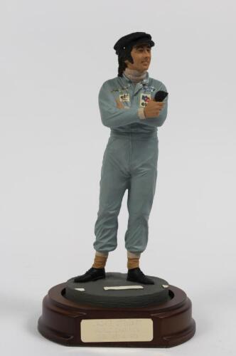 JACKIE STEWART: A 1:9 scale limited edition (380/2500) cold cast porcelain resin figure of Jackie Stewart sculpted by Paul Szeiler for Endurance Ltd, on wooden base with engraved plaque, NIB and accompanied by a COA from The Art of Sport, 20.5cm high