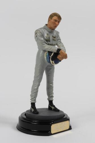 MIKA HAKKINEN: A 1:9 scale limited edition (569/2500) cold cast porcelain resin figure of Mika Hakkinen sculpted by Paul Szeiler for Endurance Ltd, on wooden base with engraved plaque, NIB and accompanied by a COA from The Art of Sport, 21cm high