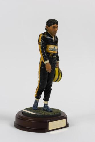 AYRTON SENNA: A 1:9 scale limited edition (3954/5000) cold cast porcelain resin figure of Ayrton Senna sculpted by Paul Szeiler for Endurance Ltd, on wooden base with engraved plaque, NIB and accompanied by a COA from The Art of Sport, 23cm high