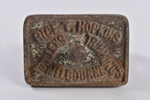 MELBOURNE HISTORY: A cast iron plate with handle, inscribed Rice T Hopkins Woollens Trimmings, Melbourne, 11cm wide