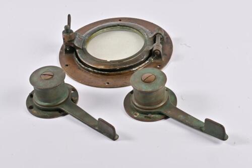 PORTHOLE: A vintage brass porthole and two brass rope ratchets, the porthole 25cm diameter