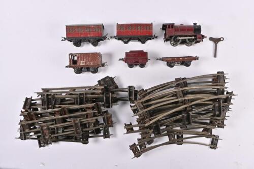 HORNBY: A Hornby type 501 LMS clockwork loco with key, including a loco, tender, four wagons and track