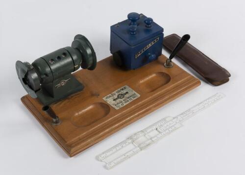 DESK SET: A Peerless Equipment promotional desk set and calendar modelled as a grinder, together with a slide rule in leather sheath