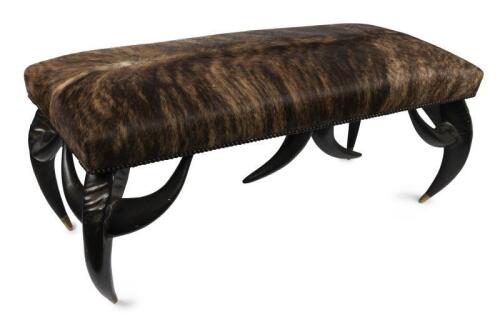 BENCH SEAT: An impressive&nbsp;heavy cowhide upholstered faux horn bench seat by Theodore Alexander, label to base, 112cm wide