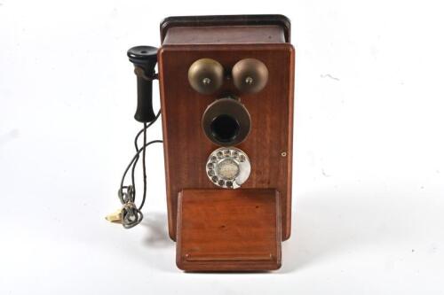 PHONE: An antique timber wall mount telephone, with 1970s wall plug fitting