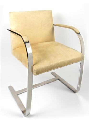 A replica &ldquo;Brno&rdquo; chair, as designed by Ludwig Mies Van Der Rohe, stainless steel frame with blonde cowhide upholstery