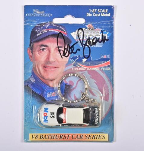 PETER BROCK: A Key Chain Holden Mobil #05, hand signed by Brock, in an opened box