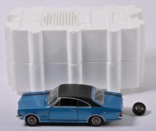 MONARO: A 1:24 scale Trax Holden HK Monaro GTS 327, blue with black stripes, front right wheel detached but present, in fitted box