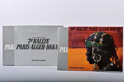 MITSUBISHI: Two RALLYE-PARIS-ALGER-DAKAR year books as prepared by MITSUBISHI MOTORS. 1985 (7th) & 1988 (10th) Yearbooks. Andrew Cowan signature