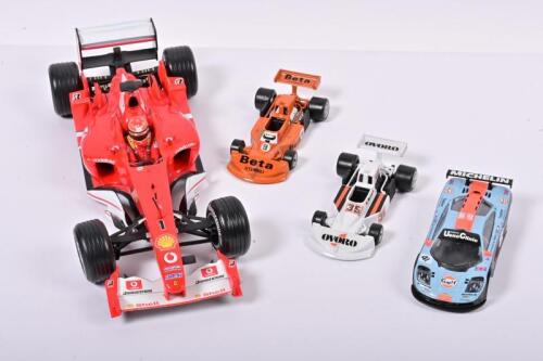 RACING CARS: A group of four racing cars predominantly related to Formula 1. 1:18 scale Hotwheels Ferrari F2003-GA & two Polistil March 761 models
