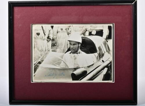 MOSS: A black and white picture of Stirling Moss sitting in a Vanwall RO98. Picture signed by Stirling Moss