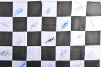 CHEQUERED FINISH LINE FLAG: An exceptional Formula One chequered finish line flag with COA, autographed by Michael Schumacher, Mark Webber, David Coulthard and 27 F1 personalities (30 signatures in total) 1520x900mm - 2