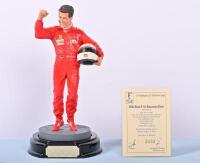 MICHAEL SCHUMACHER: A 1:9 scale limited edition (2433/5000) cold cast porcelain resin figure of Michael Schumacher sculpted by Paul Szeiler for Endurance Ltd, on wooden base with engraved plaque, NIB and accompanied by a COA from The Art of Sport, 22cm hi