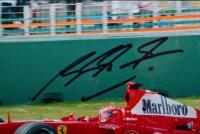 SCHUMACHER: A colour picture of Michael Schumacher driving a Ferrari F2004 at the Australian Grand Prix, Melbourne 2004. Michael Schumacher signature - 3