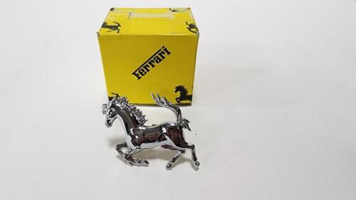 PRANCING HORSE: A NOS front chromed pressed metal&nbsp;prancing horse, with long mounting studs,&nbsp;in original box, 8cm long