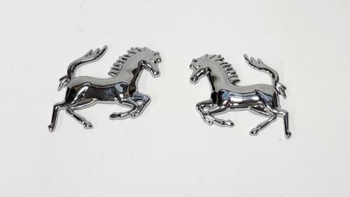 PRANCING HORSES: A pair of left and right stick on chrome plated composite prancing horses 11cm long