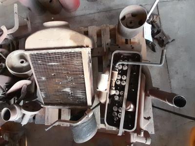 FORDSON: An early cast iron Fordson radiator & surround together with other assorted parts