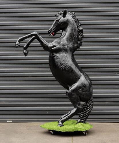 PRANCING HORSE: A life size black fibreglass prancing horse,&nbsp;