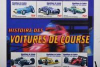 FORMULA 1: A framed Republique de Guinee issued stamp set - 'HISTOIRE DES VOITURES DE COURSE'. Grand Prix drivers signatures including Jean Alesi, Gerhard Berger, Sir Jack Brabham, Tony Brooks, Jean Pierre Jabouille, Nigel Mansell, Stirling Moss - 5