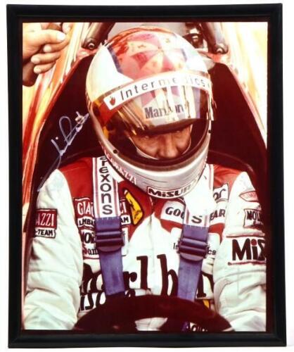 ANDRETTI: A framed and glazed colour picture of Mario Andretti sitting in the cockpit of a Ferrari 126. Mario Andretti signature