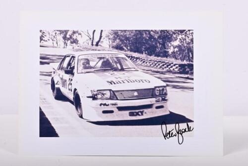 BROCK: A black and white image of Peter Brock, John Harvey, Larry Perkins racing a HDT VH Holden Commodore at Bathurst 1983. Peter Brock signature