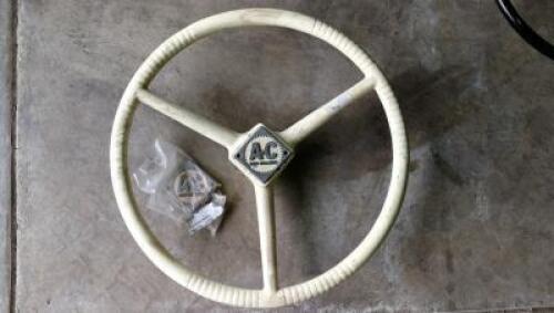 STEERING WHEEL: An ivory coloured Allis-Chalmers steering wheel with two enamel badges, 45cm diameter