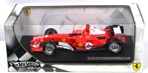 SCHUMACHER: A 1:18 scale Hotwheels Racing Ferrari F2005 as raced by Michael Schumacher