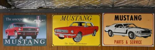 MUSTANG: Three commemorative modern tin signs, largest 29cm high x 44cm wide