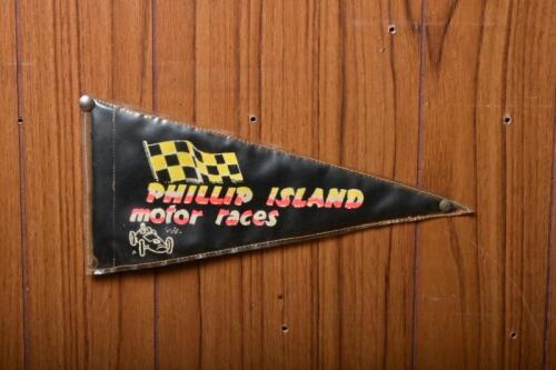 FLAG: An circa 1960s double sided fabric flag for Phillip Island Motor Races, Cowes VIC, in stitched plastic cover, 213cm high x 28cm wide