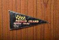 FLAG: An circa 1960s double sided fabric flag for Phillip Island Motor Races, Cowes VIC, in stitched plastic cover, 213cm high x 28cm wide