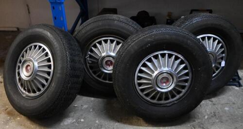 Four Mustang wheels, hubcaps and tyres, 3 fitted with Firestone Cavallino Sport 200 radial (185 SR 14 )and the other with a Goodyear