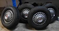Four Mustang wheels, hubcaps and tyres, 3 fitted with Firestone Cavallino Sport 200 radial (185 SR 14 )and the other with a Goodyear