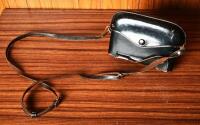 CAMERA: A early 1960s Canon 'Canonet' with fitted leather case, stamped '1580430'. - 2