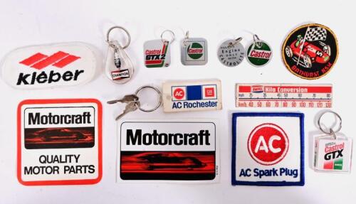 BADGES/STICKERS: A quantity of badges and stickers from various automotive companies and events including 'AC Spark Plug', 'Castrol', 'Kleber', 'Motorcraft'