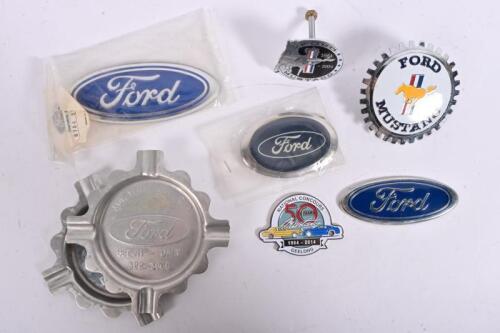 FORD: A collection of Ford related material including Ford badges, two Ford 'ADV.VEH. DEV.ENG, BEECH-DALY' aluminium ashtrays, together with three Ford Mustang badges, one a 'NATIONAL CONCOURS, 50 YEARS Mustang, 1964 - 2014', GEELONG, badge