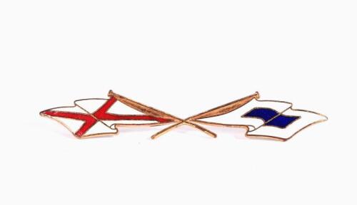 CAR EMBLEM: A car emblem enamelled brass badge, featuring two crossed semaphore flags for Victor Sierra, 13.5cm wide