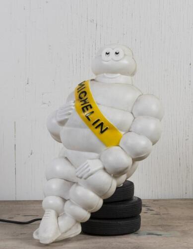 MICHELIN: A circa 1970 illuminated plastic Bibendum figure seated on three tyres as used on truck cabs, with mounting bracket, wired with Australian plug but untested, 40cm high