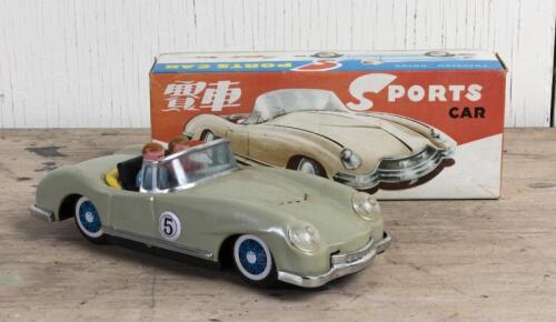 TOY CAR: A 1960s friction powered model tin toy of a sports car, with lithographed interior and wheels, NIB