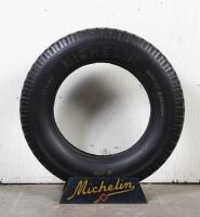 MICHELIN: A circa 19 Michelin Confort tyre on printed tin tyre stand, 88cm high overall