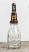 CASTROL: A circa 1950s Castrol Wakefield one imperial quart embossed glass oil bottle with early Super Grade XXL Medium Heavy tin pourer