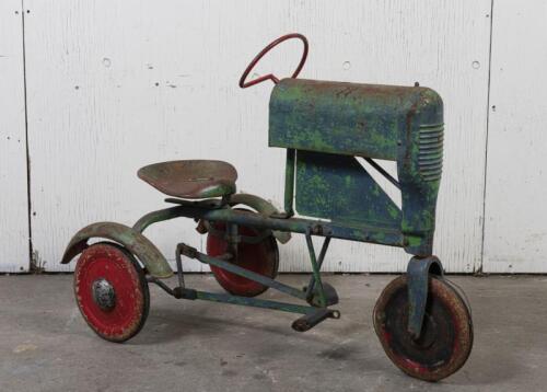TRICYCLE: A 1950s child's toy pedal tractor, 67cm high, 90cm long